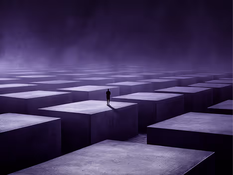 A solitary person standing on a large, elevated square block among many similar blocks in a foggy, dark purple environment.