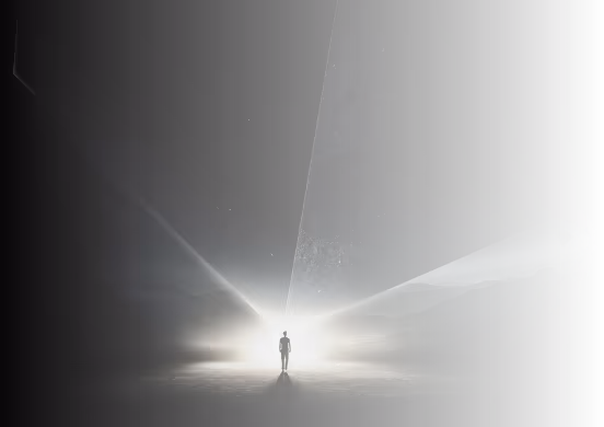 Silhouette of a person standing in a dark space illuminated by bright light beams from behind.