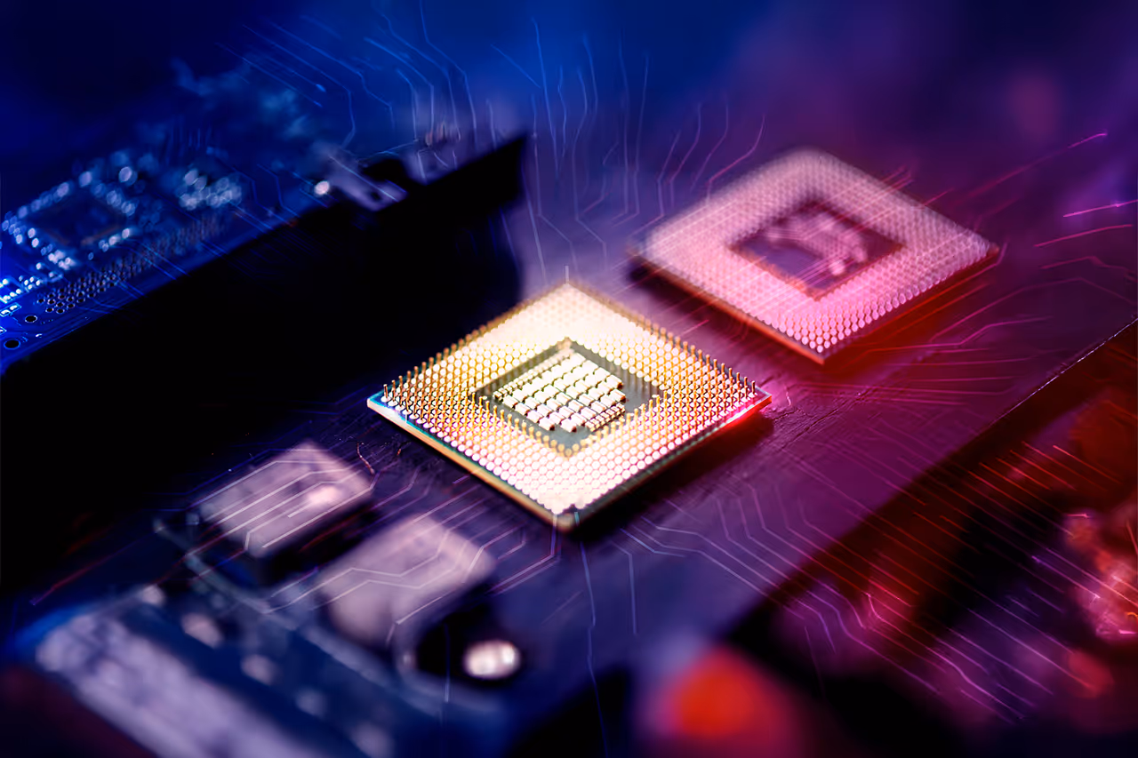 Close-up of two computer microchips on a circuit board with colorful blue and purple lighting.