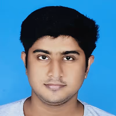 Headshot of a young man with short black hair against a blue background.